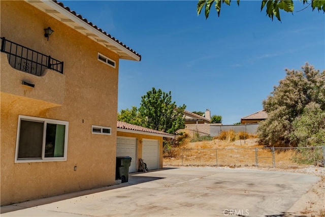 view of patio with fence and a garage