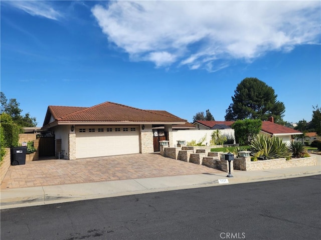1428 Blenbury Dr, Diamond Bar, CA 91765 - view of front of house featuring a tile roof, stucco siding, a garage, decorative driveway, and fence