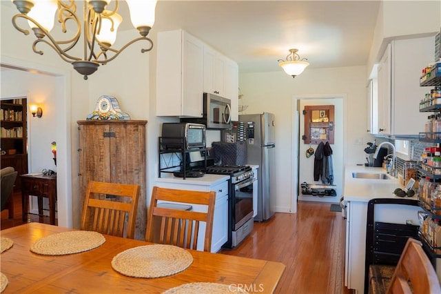 895 W 23rd St, Upland, CA 91784 - kitchen with a sink, appliances with stainless steel finishes, white cabinetry, and light countertops