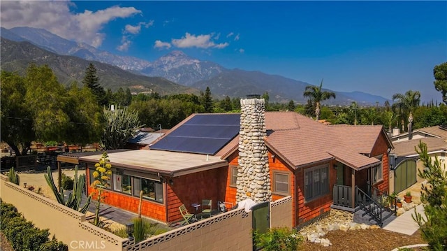 895 W 23rd St, Upland, CA 91784 - view of front facade featuring a mountain view, solar panels, and a chimney
