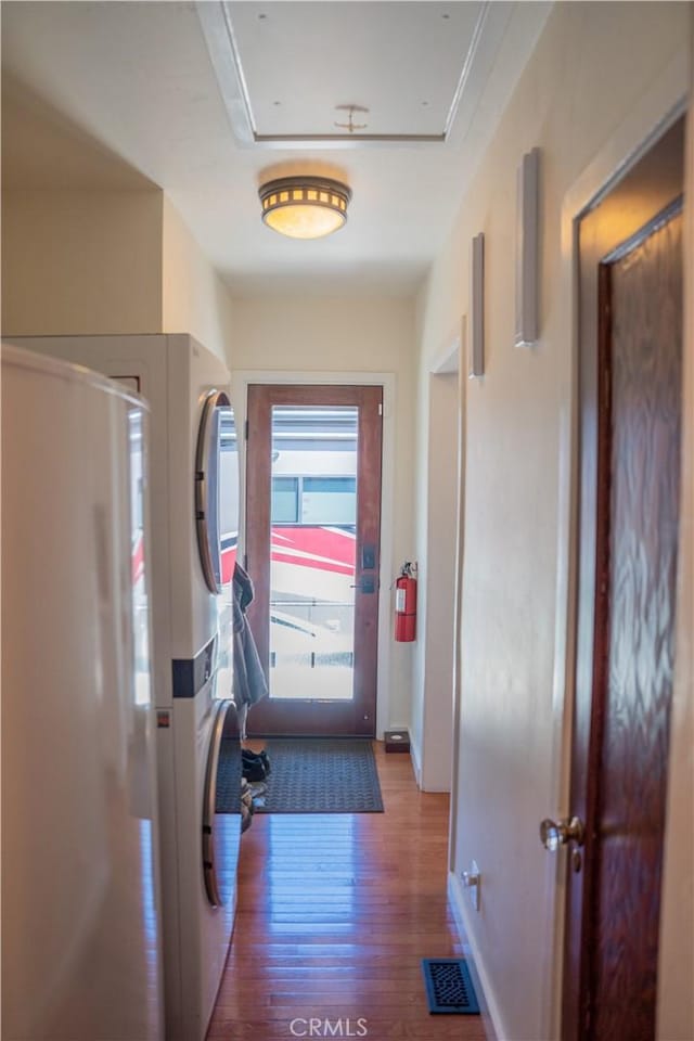 895 W 23rd St, Upland, CA 91784 - hallway with stacked washer / drying machine, wood finished floors, and baseboards