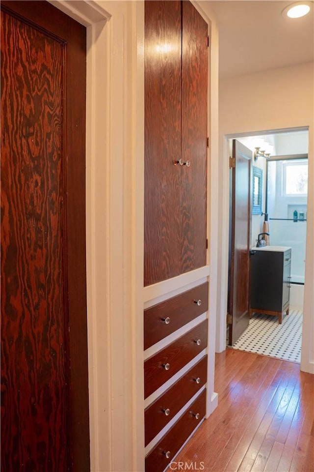 895 W 23rd St, Upland, CA 91784 - hall with hardwood / wood-style floors, a chandelier, and a sink