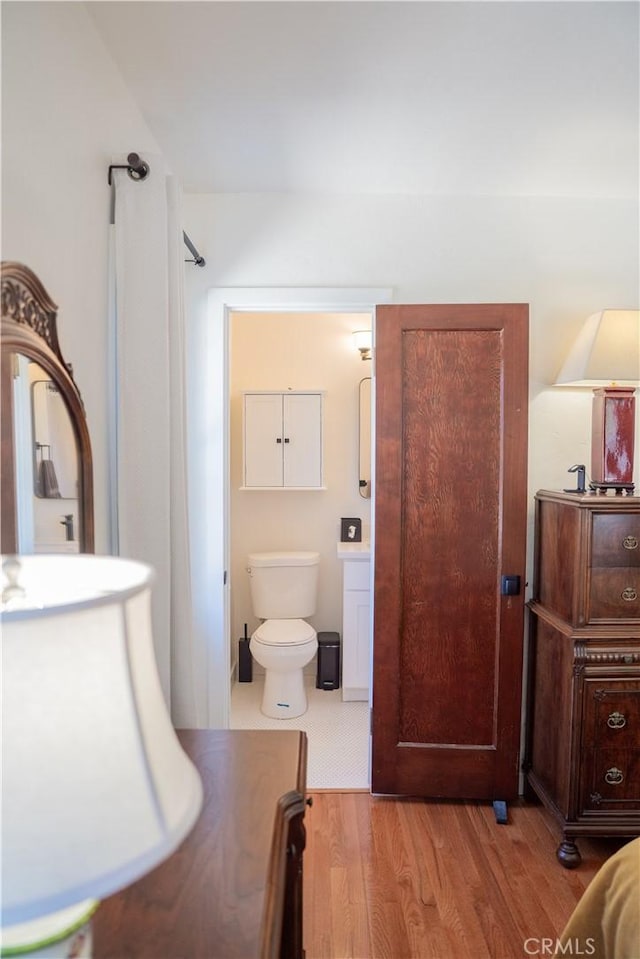 895 W 23rd St, Upland, CA 91784 - bathroom with vanity, toilet, and wood finished floors