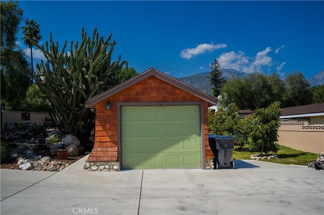 895 W 23rd St, Upland, CA 91784 - garage with concrete driveway, a mountain view, and fence