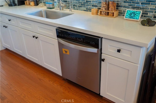 895 W 23rd St, Upland, CA 91784 - kitchen featuring stainless steel dishwasher, a sink, tasteful backsplash, and wood finished floors