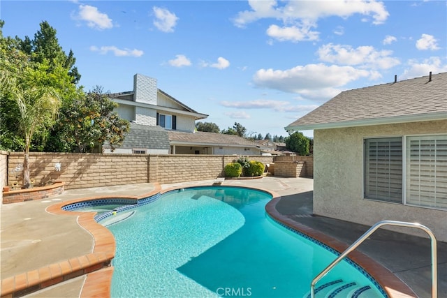 view of swimming pool featuring a fenced backyard, a patio, and a pool with connected hot tub
