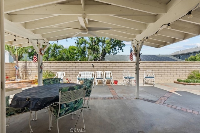 view of patio with a fenced backyard and outdoor dining area