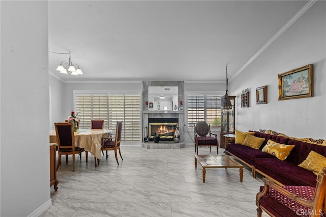 living area featuring crown molding, marble finish floors, a fireplace, a chandelier, and baseboards