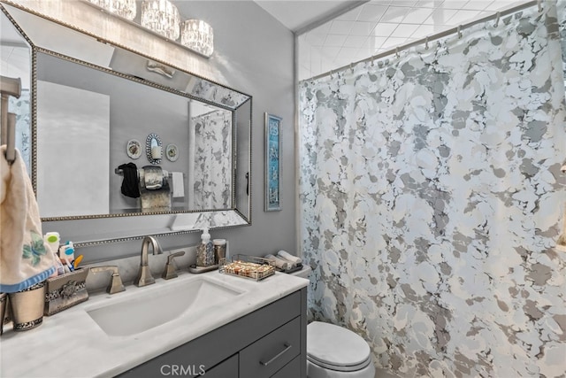 bathroom with toilet, vanity, and a shower with shower curtain