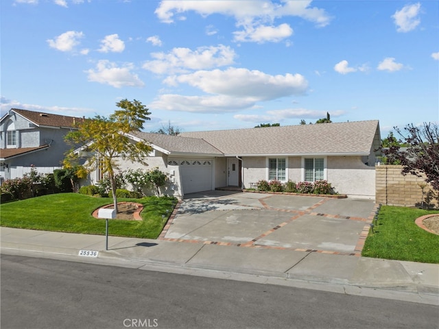 single story home with driveway, an attached garage, a front yard, stucco siding, and a shingled roof