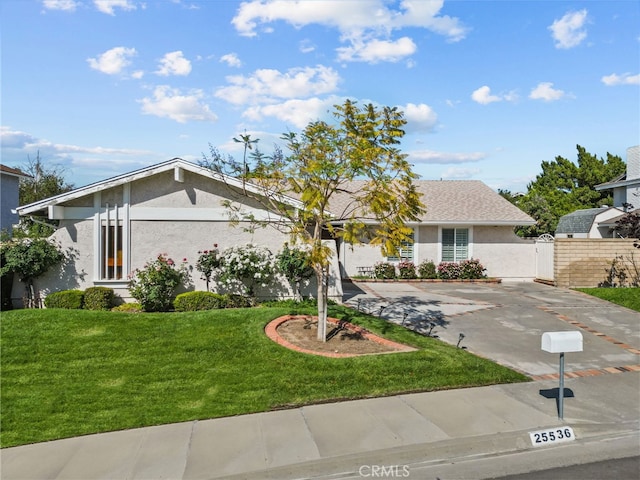 view of front facade featuring stucco siding and concrete driveway