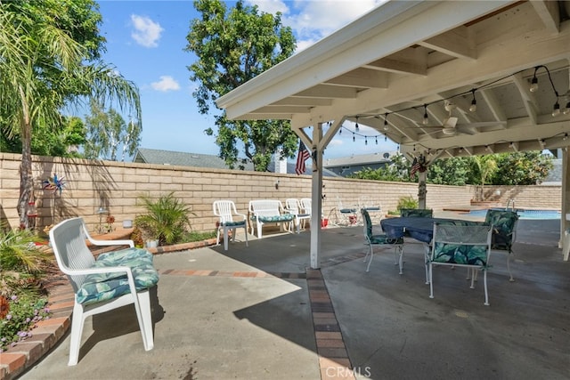 view of patio / terrace with a fenced backyard, ceiling fan, and outdoor dining area