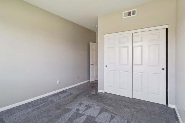 31332 Bluebeech Ct, Temecula, CA 92592 - unfurnished bedroom featuring dark carpet and a closet