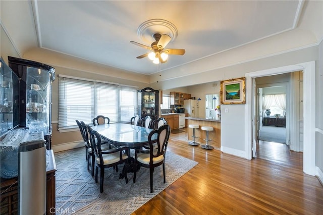 851 Crenshaw Blvd, Los Angeles, CA 90005 - dining area featuring ceiling fan, light wood-type flooring, baseboards, and a raised ceiling