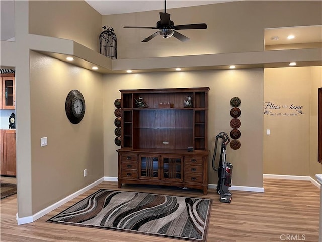 1321 Cypress Point Dr, Banning, CA 92220 - office featuring light wood finished floors, baseboards, a ceiling fan, recessed lighting, and a high ceiling