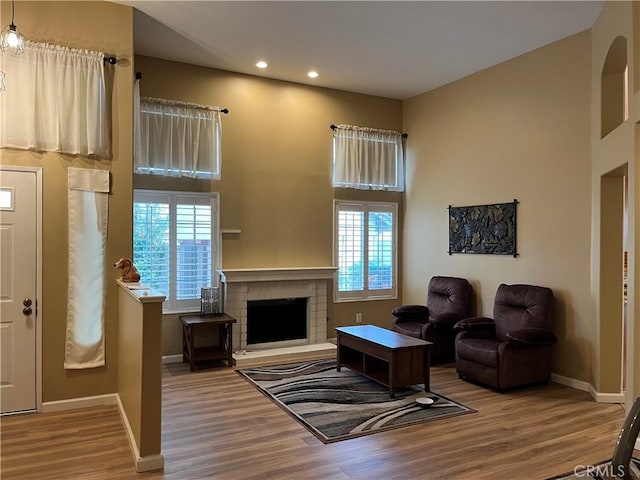 1321 Cypress Point Dr, Banning, CA 92220 - living area with wood finished floors, recessed lighting, baseboards, and a fireplace