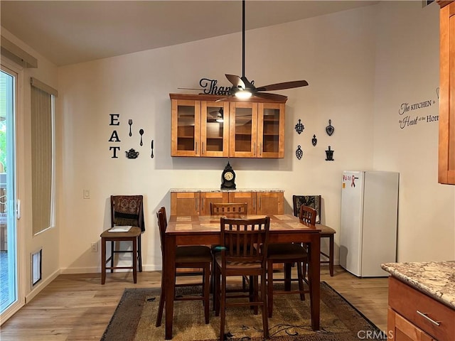 1321 Cypress Point Dr, Banning, CA 92220 - dining room with wood finished floors, a ceiling fan, and baseboards