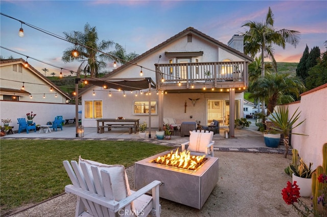 3388 Tonopah St, Oceanside, CA 92054 - rear view of property with an outdoor fire pit, a patio, stucco siding, and a balcony