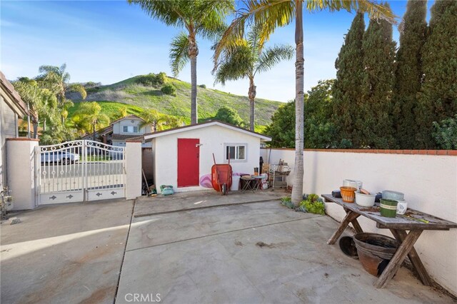 3388 Tonopah St, Oceanside, CA 92054 - view of patio / terrace featuring a mountain view, a gate, fence, and an outdoor structure