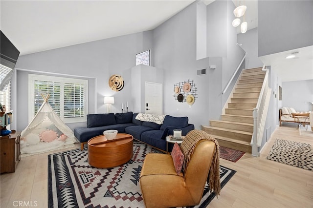 3388 Tonopah St, Oceanside, CA 92054 - living room with high vaulted ceiling, stairs, and wood finished floors