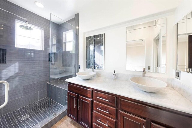 127 Lessay, Newport Coast, CA 92657 - full bath with a tile shower, double vanity, and tile patterned floors