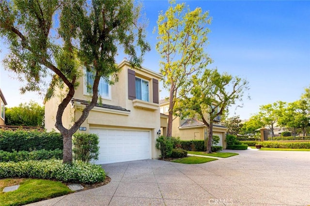 127 Lessay, Newport Coast, CA 92657 - view of front of house featuring driveway, an attached garage, and stucco siding