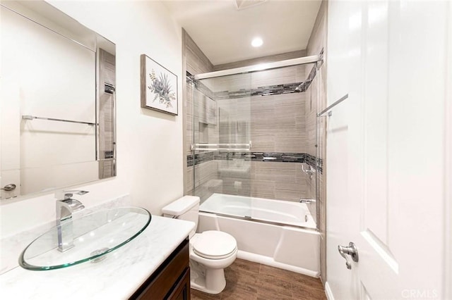 127 Lessay, Newport Coast, CA 92657 - full bathroom featuring vanity, toilet, wood finished floors, shower / bath combination with glass door, and recessed lighting