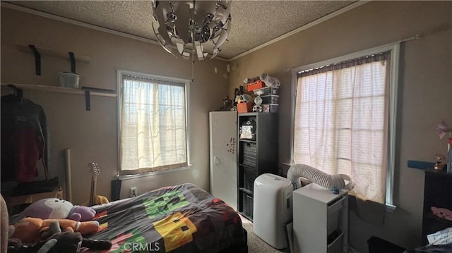 bedroom featuring a chandelier, a textured ceiling, and crown molding