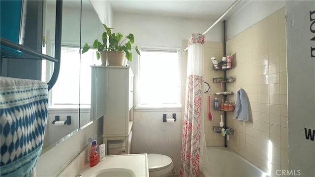 full bath featuring toilet, shower / bath combination with curtain, and vanity