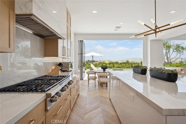 4177 Prado De Los Pajaros, Calabasas, CA 91302 - kitchen featuring stainless steel gas cooktop, premium range hood, tasteful backsplash, light stone countertops, and light brown cabinets