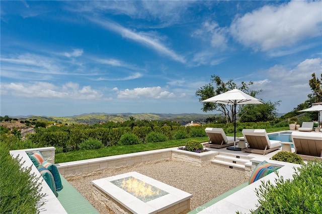 4177 Prado De Los Pajaros, Calabasas, CA 91302 - view of patio / terrace with an outdoor fire pit, an outdoor pool, and a mountain view