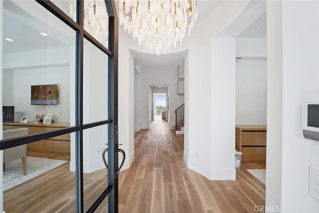 4177 Prado De Los Pajaros, Calabasas, CA 91302 - corridor featuring light wood-type flooring, a chandelier, and baseboards