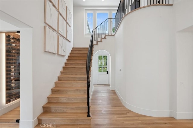 4177 Prado De Los Pajaros, Calabasas, CA 91302 - stairway with wood finished floors, a towering ceiling, and baseboards