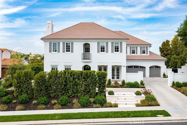 4177 Prado De Los Pajaros, Calabasas, CA 91302 - view of front of house with driveway, a chimney, stucco siding, a garage, and french doors