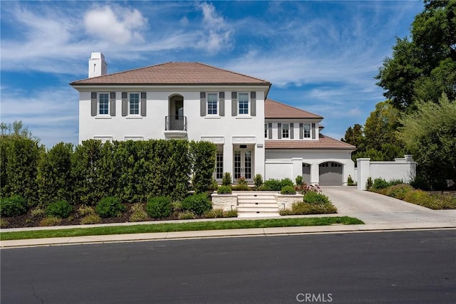 4177 Prado De Los Pajaros, Calabasas, CA 91302 - view of front of house featuring a chimney, concrete driveway, stucco siding, a balcony, and a garage