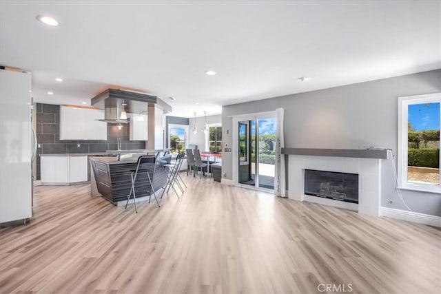 16 Vistamar Dr, Laguna Niguel, CA 92677 - kitchen featuring modern cabinets, white cabinets, decorative backsplash, freestanding refrigerator, and light wood-type flooring