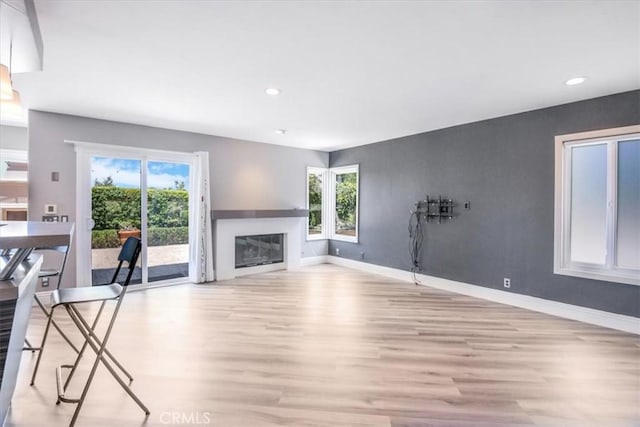 16 Vistamar Dr, Laguna Niguel, CA 92677 - unfurnished living room with light wood-type flooring, plenty of natural light, a glass covered fireplace, and recessed lighting