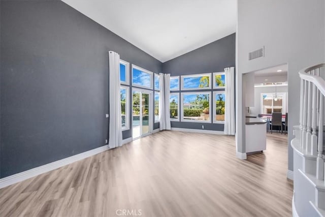 16 Vistamar Dr, Laguna Niguel, CA 92677 - unfurnished living room featuring wood finished floors, high vaulted ceiling, and plenty of natural light