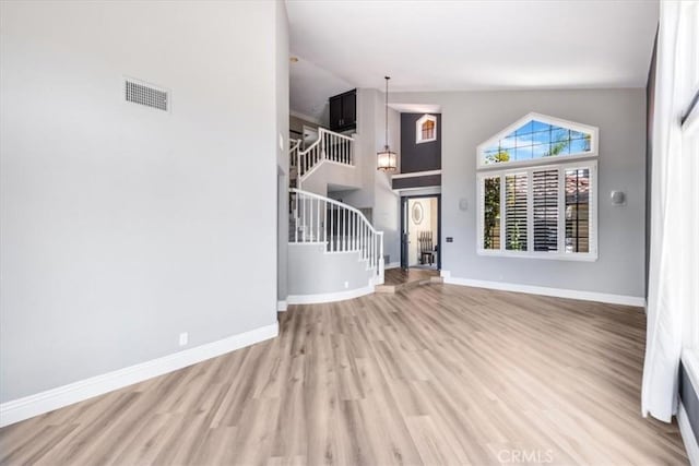 16 Vistamar Dr, Laguna Niguel, CA 92677 - unfurnished living room with stairs, wood finished floors, and high vaulted ceiling