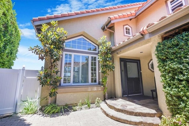 16 Vistamar Dr, Laguna Niguel, CA 92677 - view of exterior entry featuring stucco siding and a tile roof