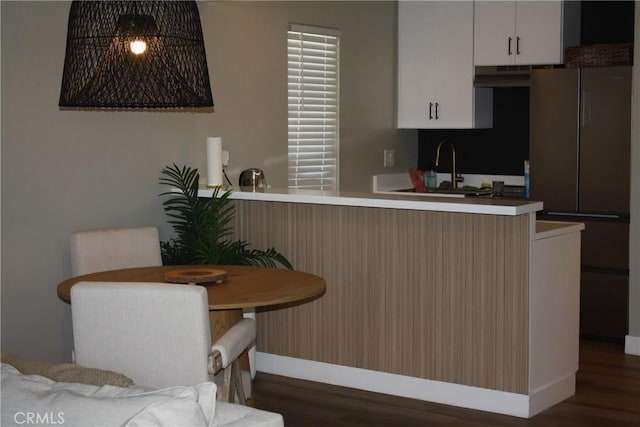 28691 Via Las Flores Unit 326, Murrieta, CA 92563 - kitchen with dark wood-style flooring, baseboards, white cabinets, and light countertops