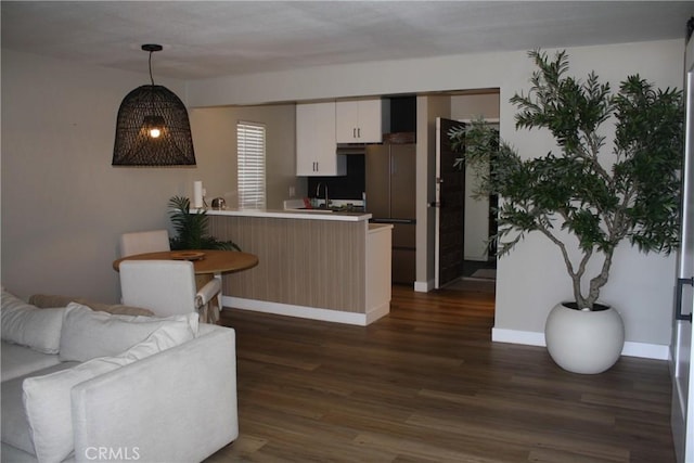 28691 Via Las Flores Unit 326, Murrieta, CA 92563 - kitchen with a peninsula, dark wood-style flooring, white cabinets, pendant lighting, and open floor plan