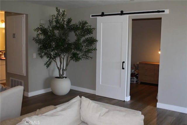 28691 Via Las Flores Unit 326, Murrieta, CA 92563 - bedroom with a barn door, baseboards, and wood finished floors
