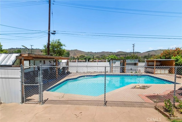 2271 Kellogg Park Dr, Pomona, CA 91768 - view of swimming pool with a mountain view, fence, and a patio area