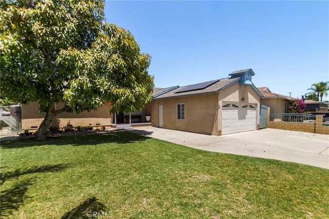 2271 Kellogg Park Dr, Pomona, CA 91768 - view of side of home with stucco siding, solar panels, concrete driveway, and a garage