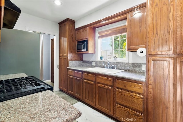 2271 Kellogg Park Dr, Pomona, CA 91768 - kitchen with a sink, stainless steel appliances, light countertops, and light marble finish floors