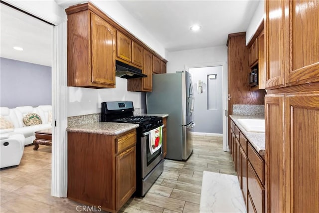 2271 Kellogg Park Dr, Pomona, CA 91768 - kitchen featuring appliances with stainless steel finishes, under cabinet range hood, light countertops, brown cabinetry, and recessed lighting