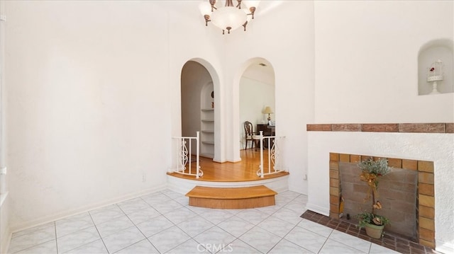 1511 Coolidge Ave, Pasadena, CA 91104 - hall with arched walkways, a high ceiling, a chandelier, and tile patterned flooring