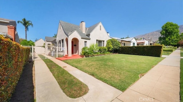 1511 Coolidge Ave, Pasadena, CA 91104 - view of front facade with a gate, stucco siding, a chimney, and a mountain view