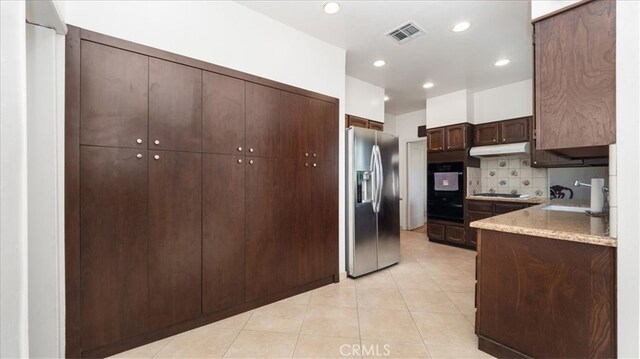 1511 Coolidge Ave, Pasadena, CA 91104 - kitchen with stainless steel fridge with ice dispenser, under cabinet range hood, black oven, light tile patterned flooring, and gas cooktop